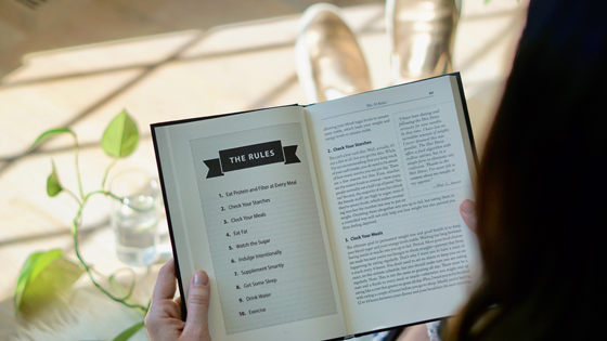 A woman is reading the rules or bylaws relating to her not-for-profit.