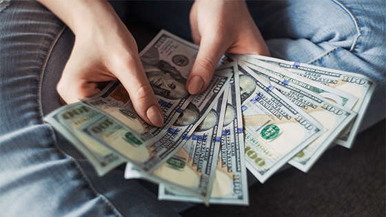 woman holding hundred dollar bills fanned out; image used for blog post about options if individuals can