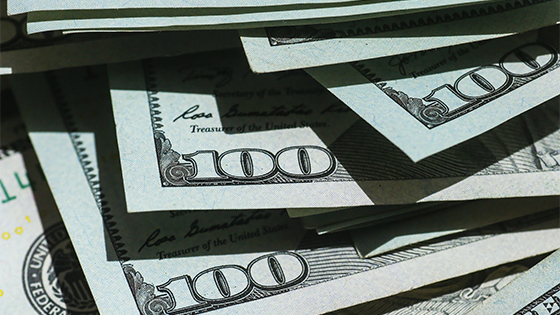one-hundred dollar bills stacked on top of each other; image used for blog post about planning income tax for estate plan