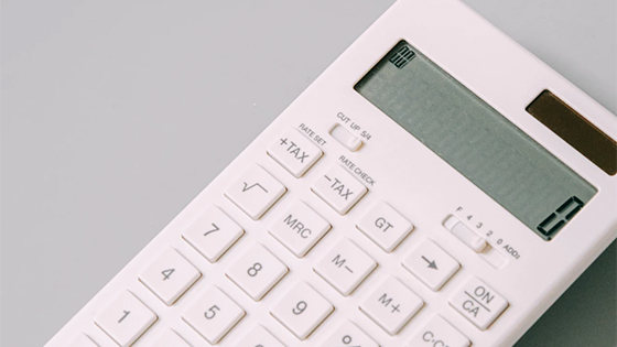 white calculator with the number 0 on screen; image used for blog post about tax savings for small businesses