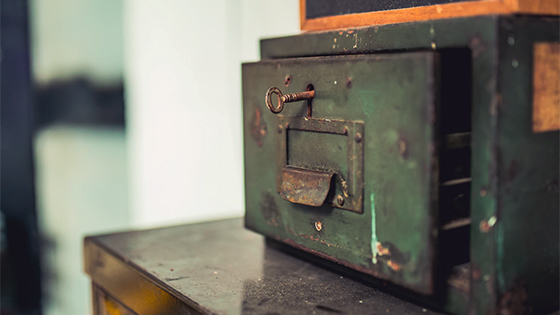a vintage green safe sitting on a wooden table with a key in the lock; image used for blog post about not-for-profits rebuilding their operating reserve a vintage green safe sitting on a wooden table with a key in the lock; image used for blog post about not-for-profits rebuilding their operating reserve
