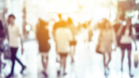 a small crowd of people walking inside a building; image used for blog post about not-for-profits prioritizing common interests