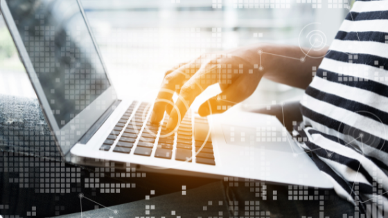 someone typing on their laptop with an overly image of technology glow; image used for blog post about research credit election
