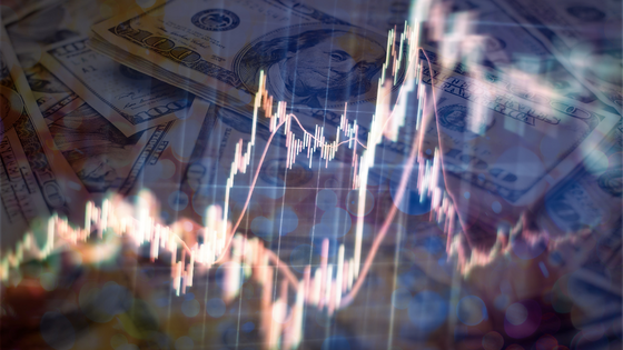 An image of financial stock lines overlayed on top of hundred dollar bills; image used for blog post about municipal bonds