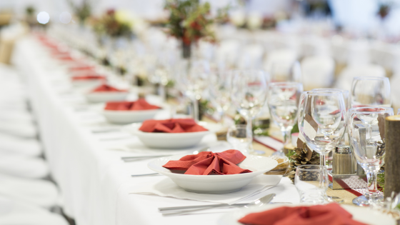 Photo of a table with plate settings and wine glasses; for blog post about tax reporting for special events
